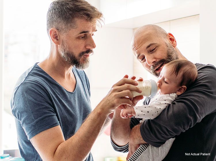 happy homosexual couple with baby
